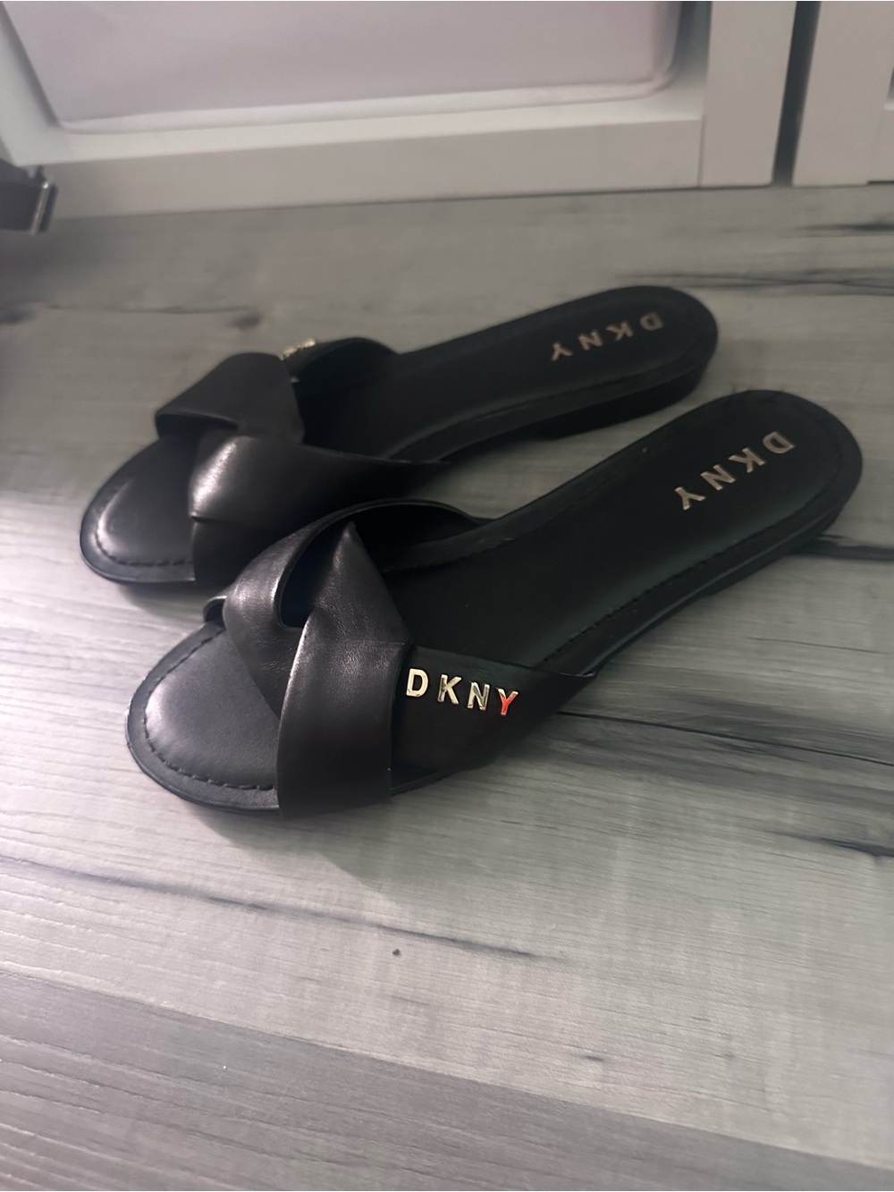DKNY Black Twist Strap Slide Sandals with Gold Logo Accent